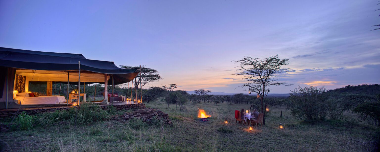 Kicheche Valley Camp in Naboisho Conservancy with a luxury safari tent, campfire, and private bush dinner at sunset.
