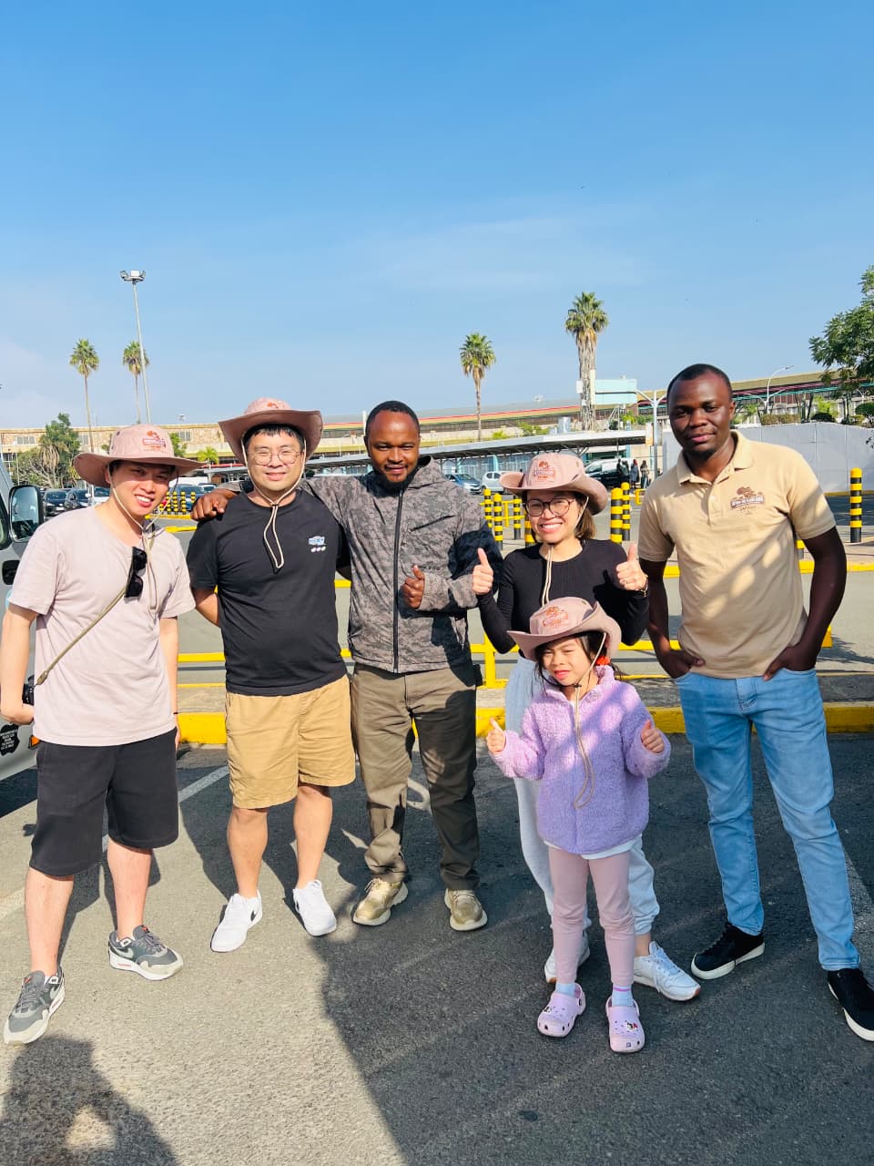 Chinese travellers welcomed by safari guide at Jomo Kenyatta International Airport Nairobi