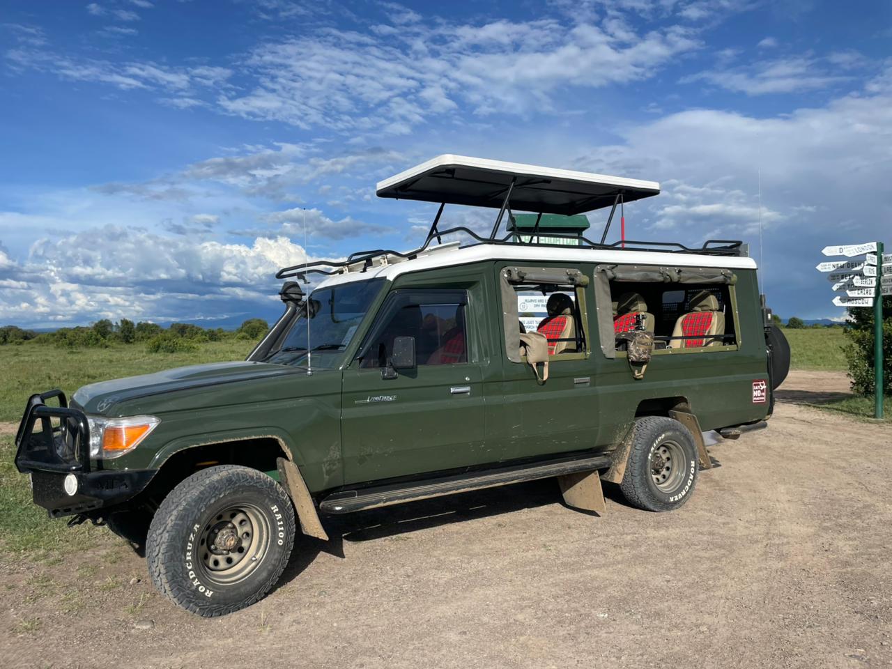 Kenya safari Land Cruiser with pop-up roof parked in the Maasai Mara