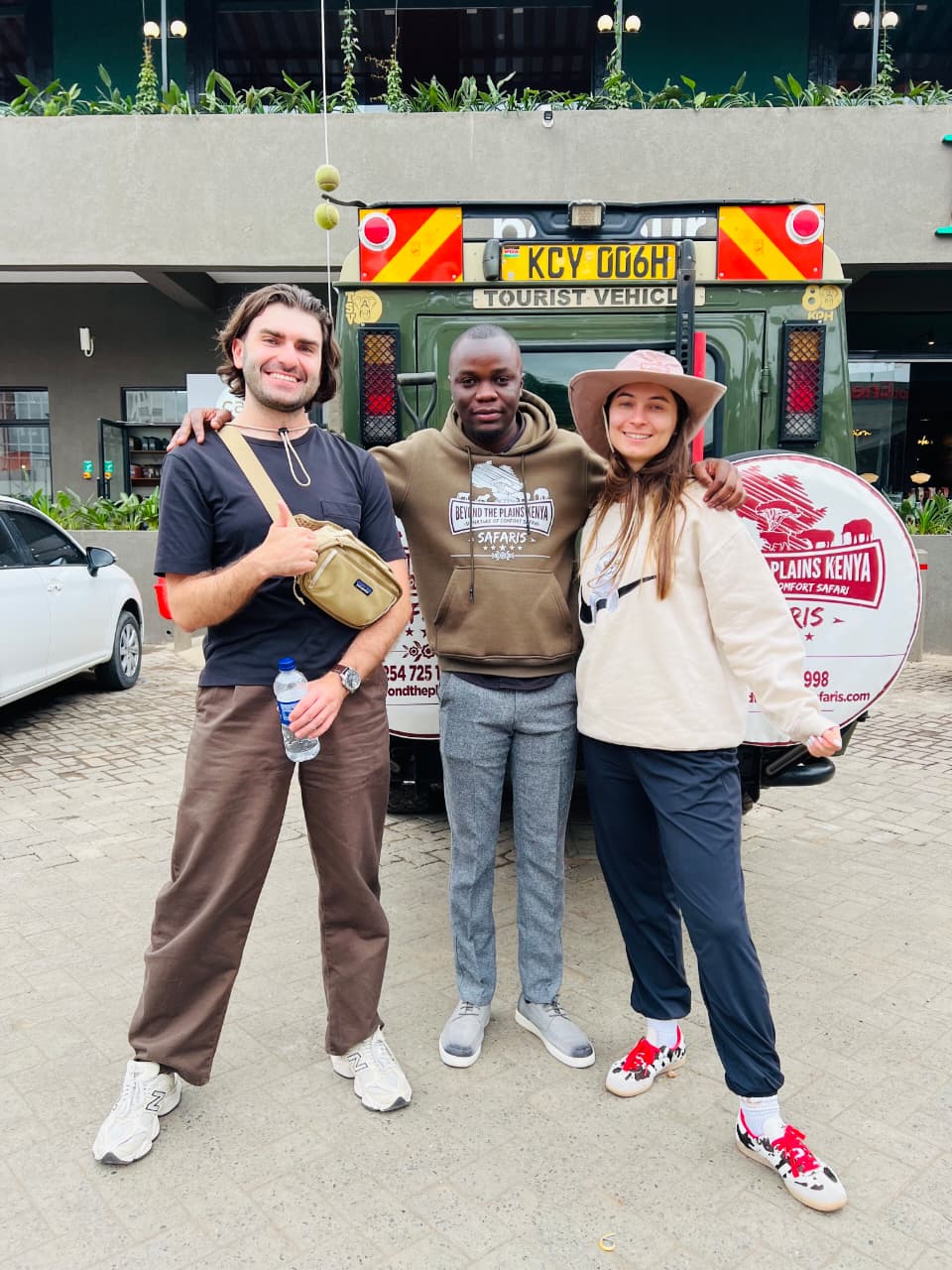 Travelers with their Beyond The Plains Safaris guide and safari vehicle in Nairobi, Kenya
