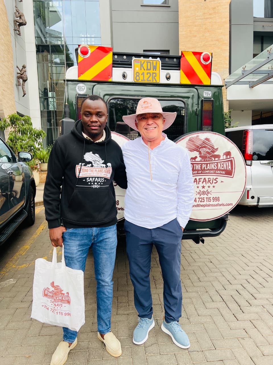 Beyond the Plains Safaris team member with a branded safari vehicle in Nairobi